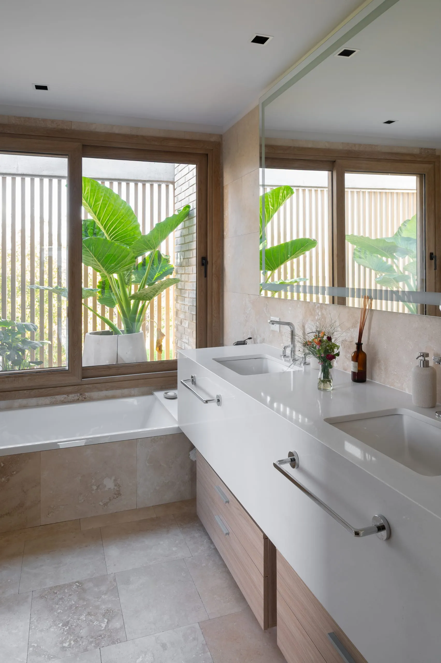 Baño con doble bacha y ventana con plantas
